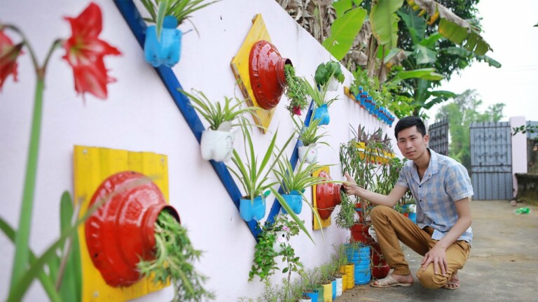 Colorful flower garden, recycled plastic bottle growing flowers on the wall